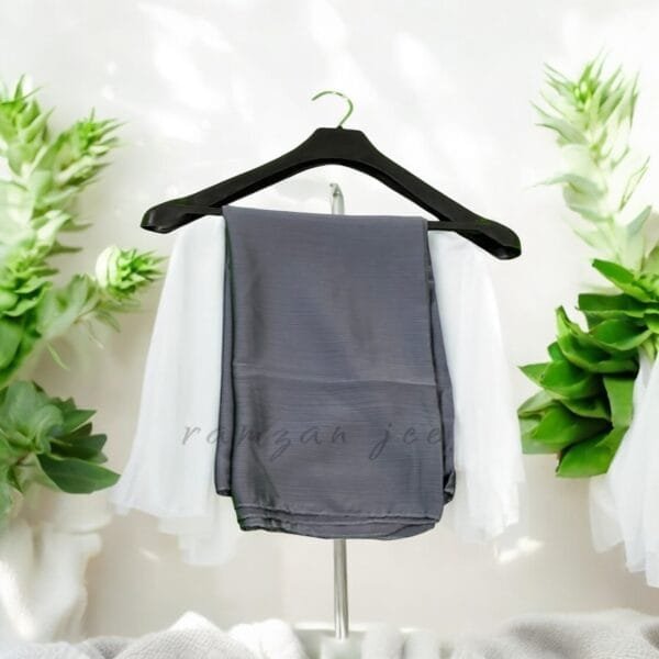 "Elegant silk hijab in soft chiffon fabric, perfect for modest fashion." "Lightweight and breathable silk hijab in classic black for full coverage."