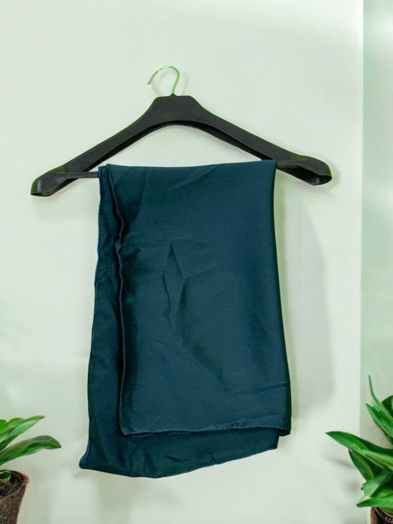 "Versatile long hijab styled for casual and formal occasions." "Premium modest fashion hijab draped elegantly over shoulders." "Rich-colored long hijab with full-length coverage and a soft finish."