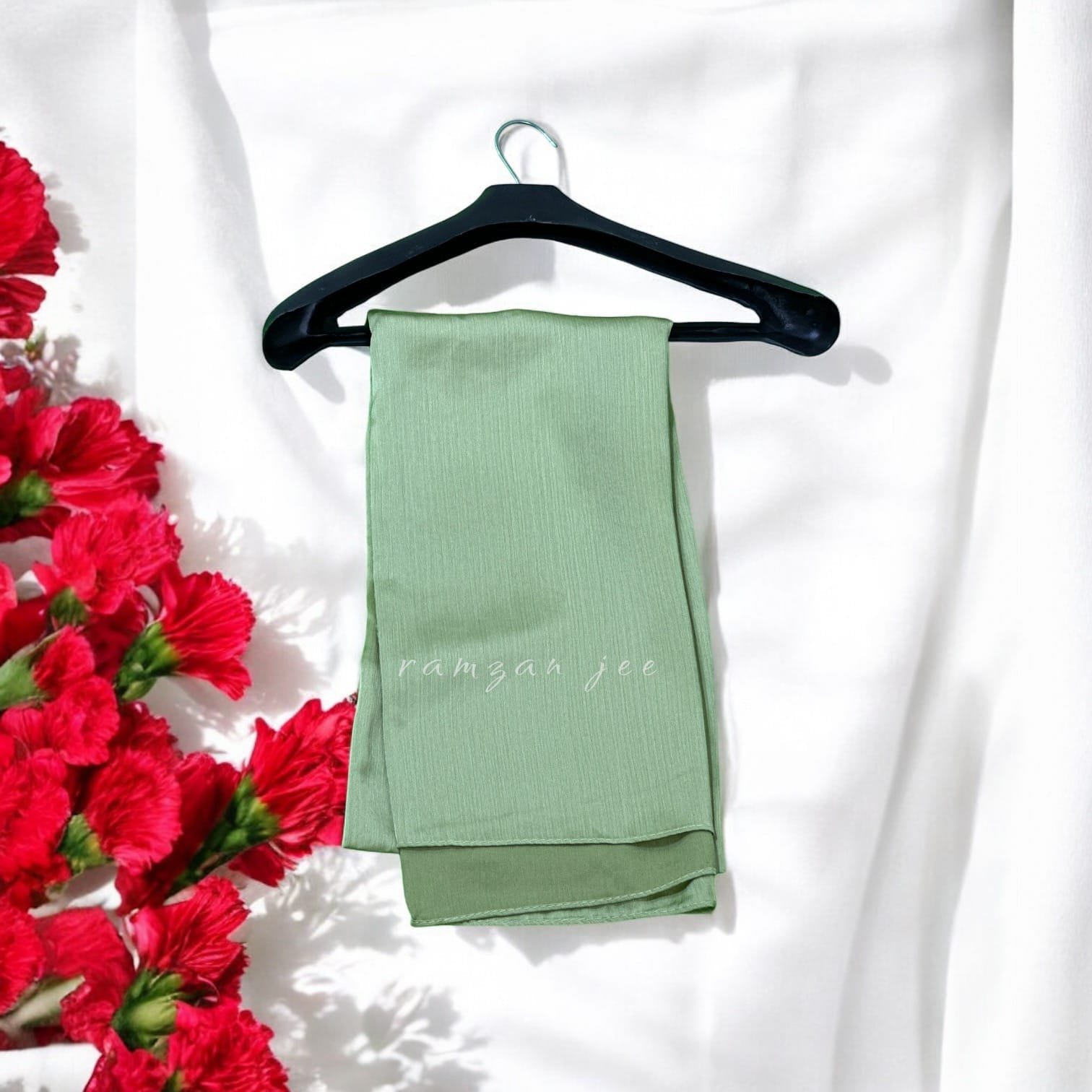 "Premium modest fashion silk hijab draped elegantly over shoulders."