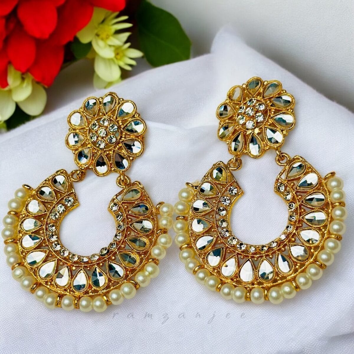 "Elegant earrings with intricate designs, perfect for formal events and evening wear. Available in statement chandelier and drop styles."