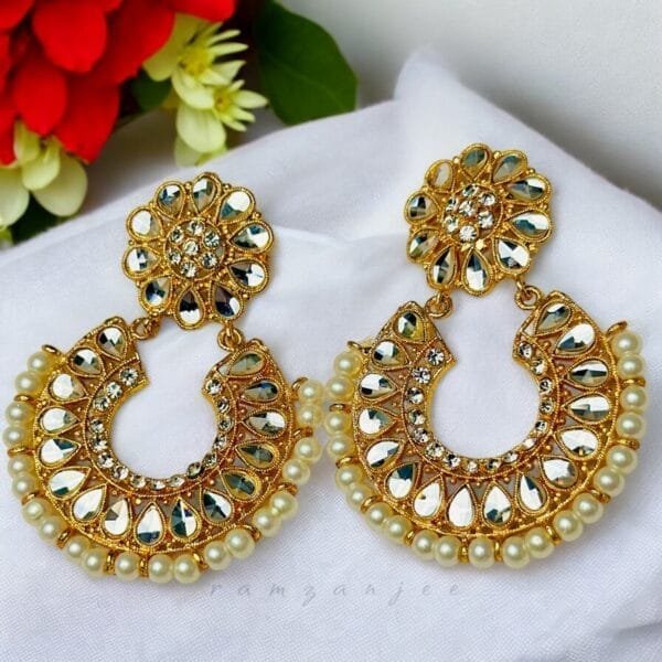 "Elegant earrings with intricate designs, perfect for formal events and evening wear. Available in statement chandelier and drop styles."