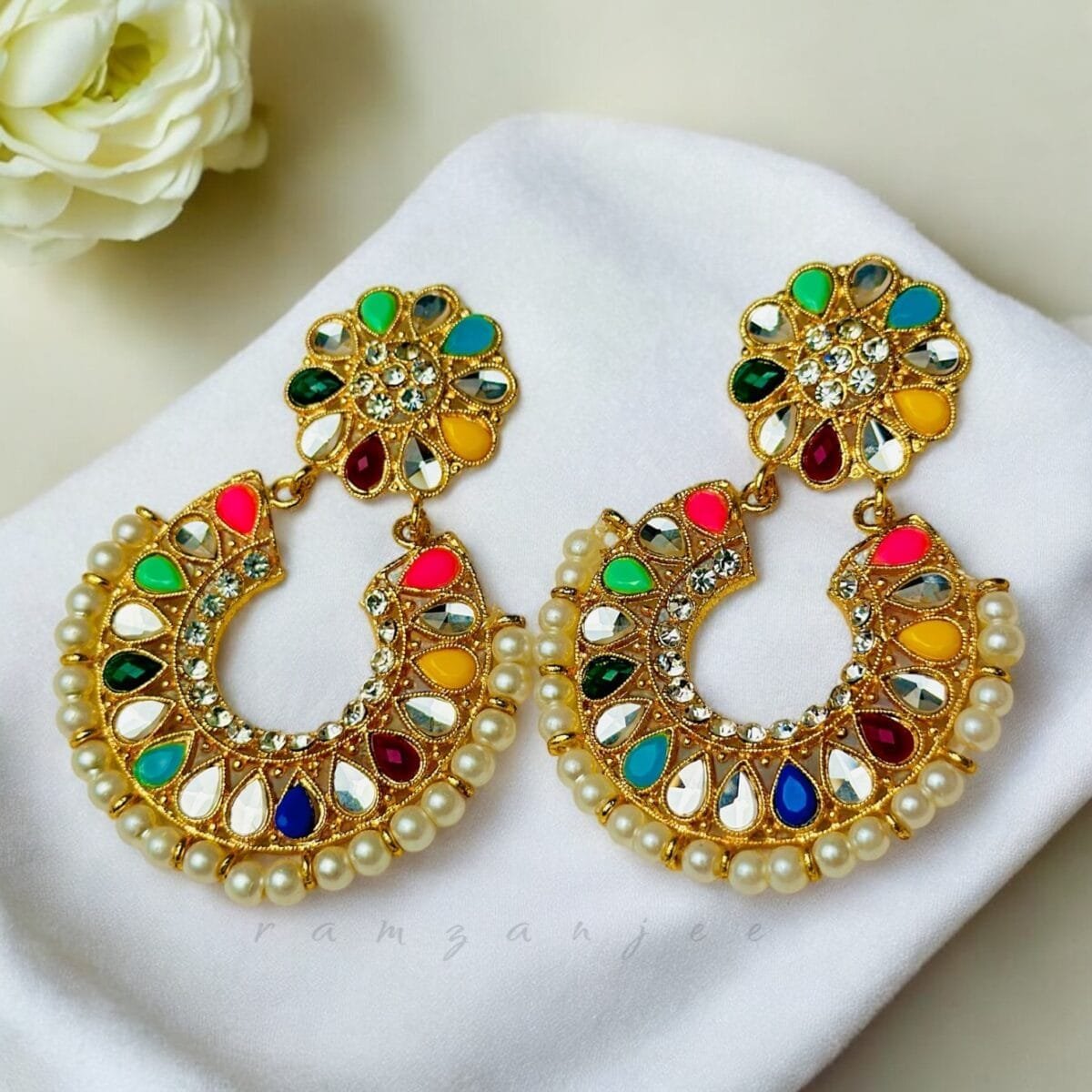 "Elegant earrings with intricate designs, perfect for formal events and evening wear. Available in statement chandelier and drop styles."