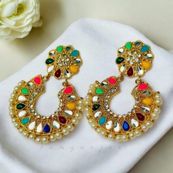 "Elegant earrings with intricate designs, perfect for formal events and evening wear. Available in statement chandelier and drop styles."