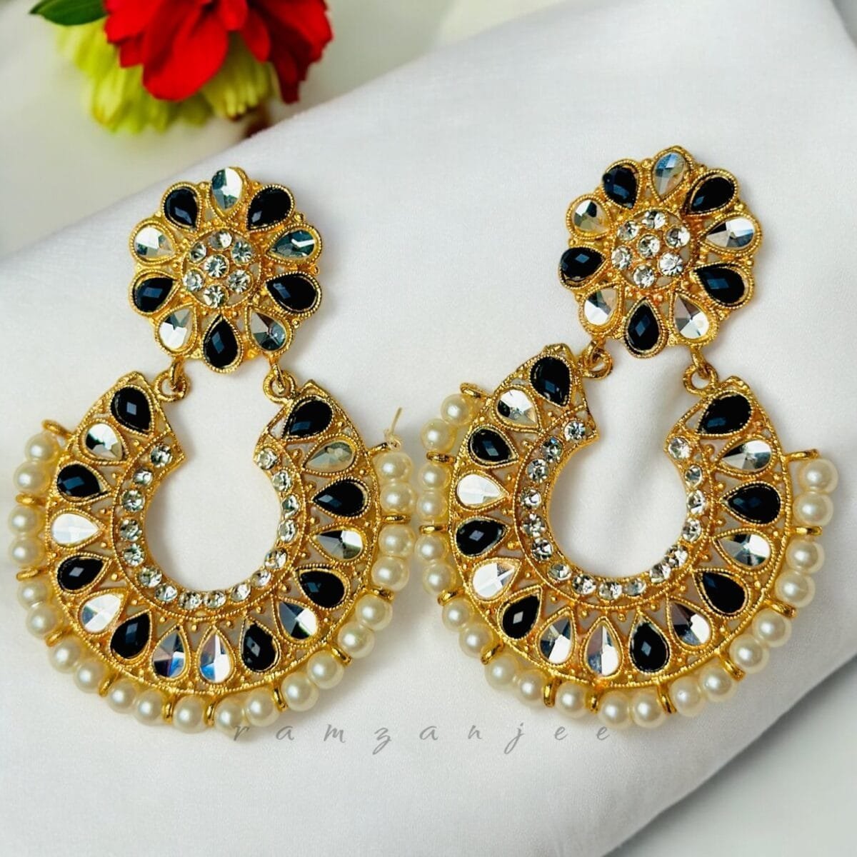 "Elegant earrings with intricate designs, perfect for formal events and evening wear. Available in statement chandelier and drop styles."